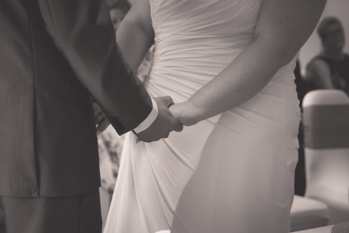 black and white bride and groom holding hands.
